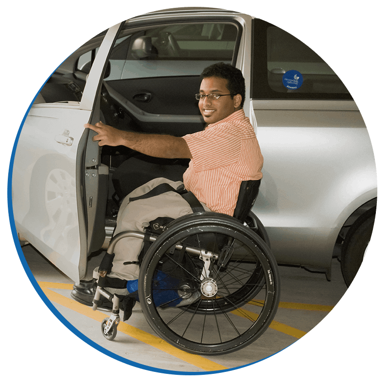 A disabled student in a wheelchair around the college campus